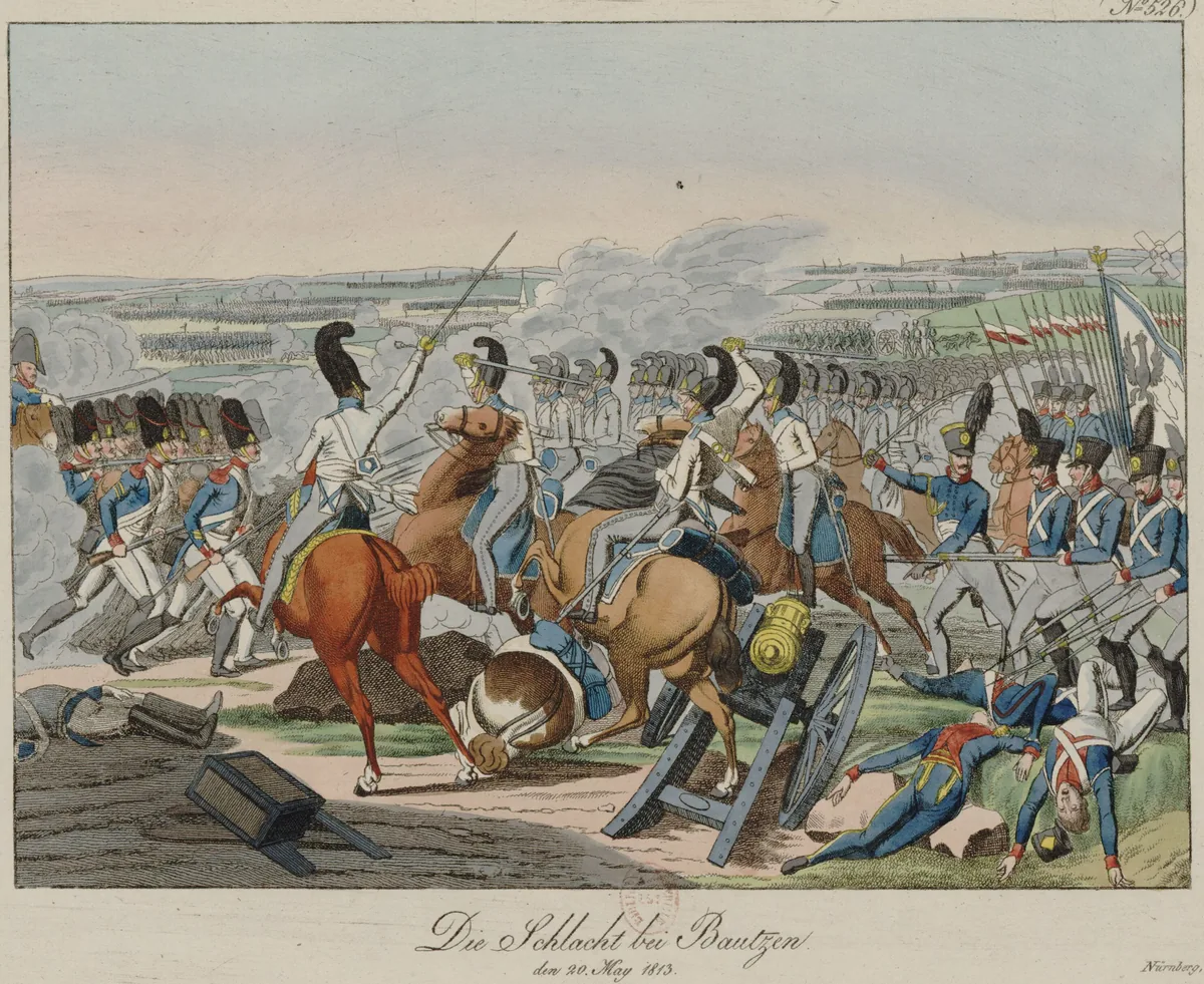 Hand-coloured engraving: horsemen in white coats and black-crested helmets charge among infantrymen in blue coats wearing bearskins or shakos; in the foreground an overturned cannon and fallen soldiers, on the right a flag bearing an eagle, and in the distance lines of troops on the hills