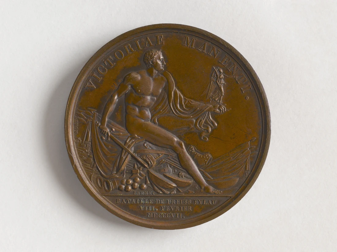 Bronze medal: a figure seated on a heap of arms and flags, holding a sword and a small Victory