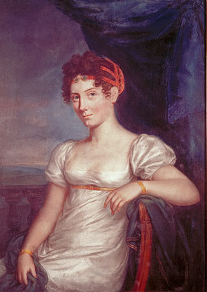 Half-length portrait of Stéphanie de Beauharnais (1789-1860), Grand Duchess of Baden — seated three-quarters view, white high-waisted Empire gown, short puffed sleeves, square neckline, red jewelled bandeau across the forehead, gold bracelets; left arm on the back of a chair in dark drapery; stone balustrade and pale sky to the left, deep blue curtains to the right; Neoclassical oil, First French Empire